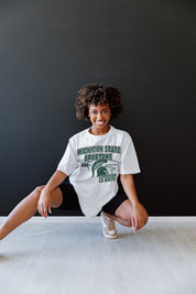 White Michigan State Spartans In The Lead Oversized Tee - On Model Seated | Gameday Couture - SOHO