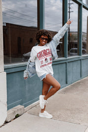 Ivory GEORGIA BULLDOGS Unity Oversized Tee - Seated Outdoor Lifestyle Shot with Wide-Leg Jeans | Gameday Couture - SOHO