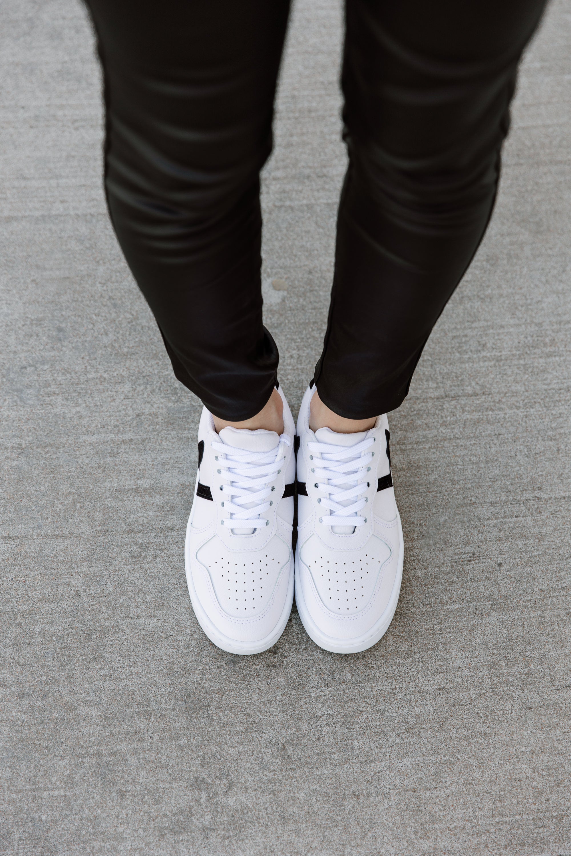 black trainers with white stripe