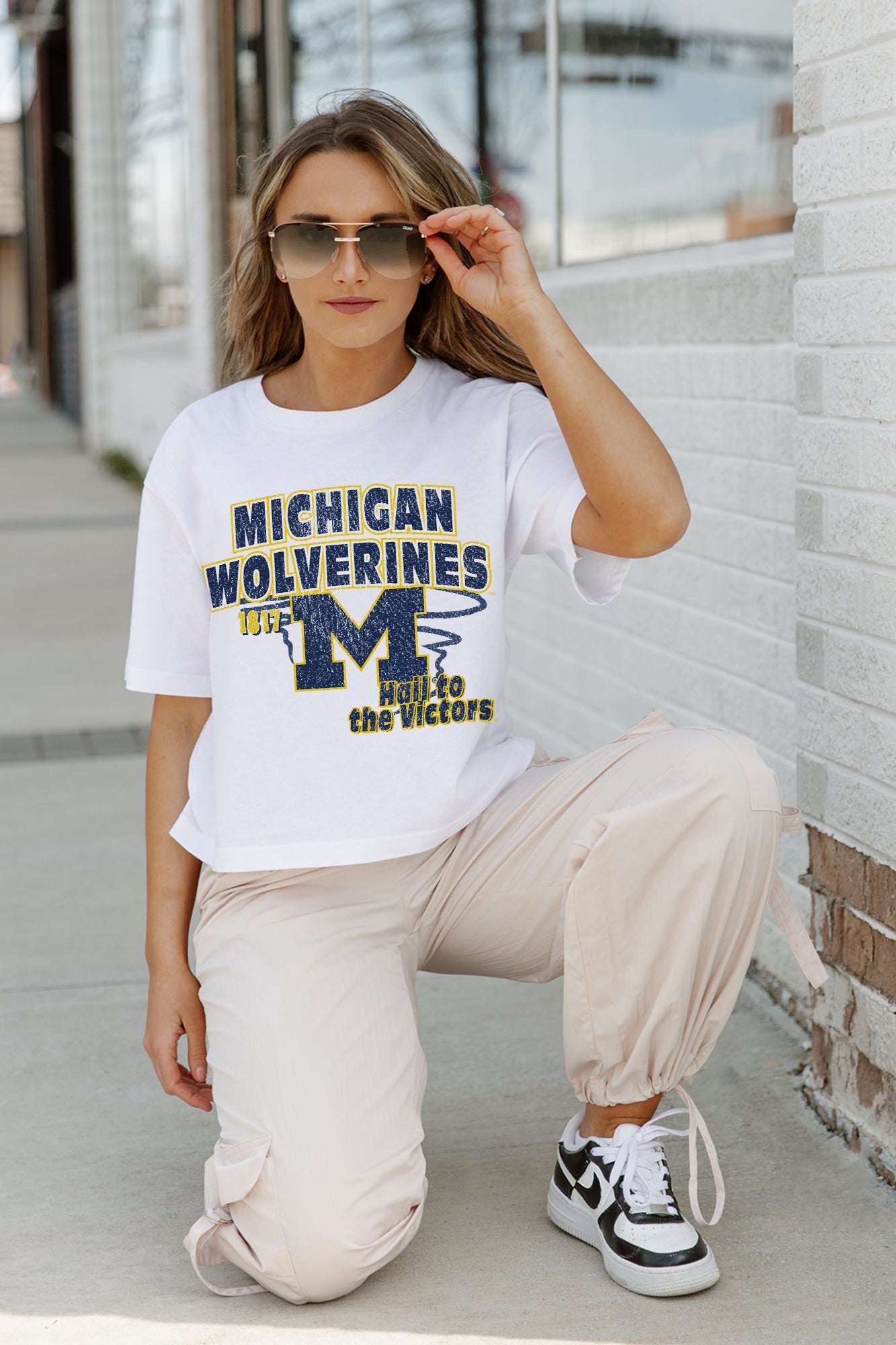 White Michigan Wolverines GAMEDAY GOALS Boxy-Fit Crop Tee - On Model Kneeling Street Style | Gameday Couture - SOHO