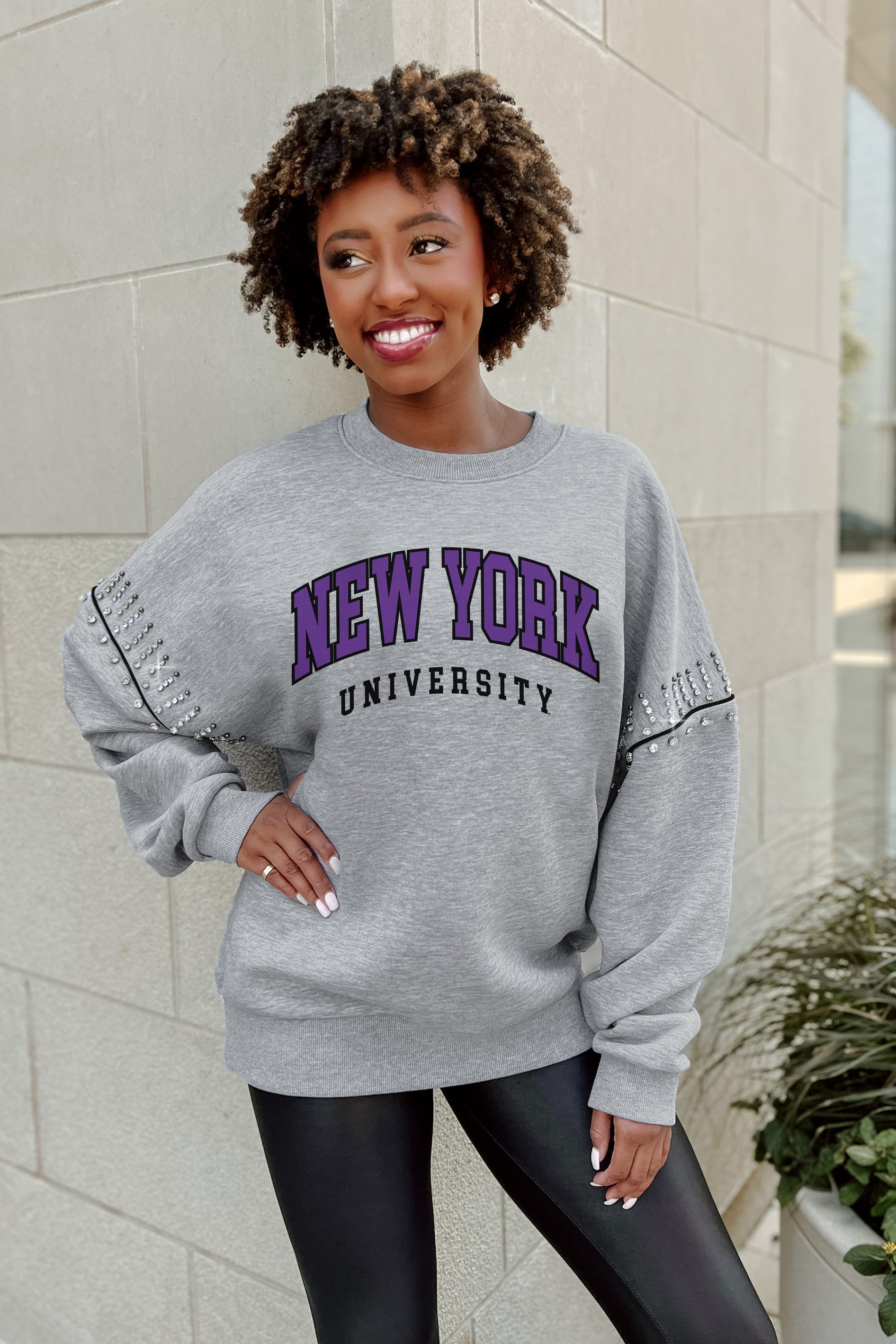 NEW YORK UNIVERSITY VIOLETS COMPETITIVE EDGE FLEECE PULLOVER WITH JEWEL SLEEVE EMBELLISHMENTS