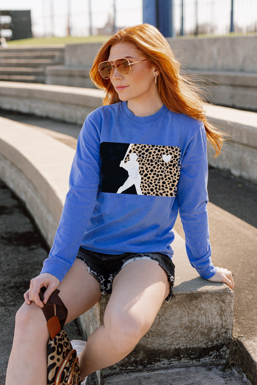 HEART ON THE FIELD Blue Vintage Wash Long Sleeve Baseball Graphic Tee - On Model Seated | Gameday Couture - SOHO